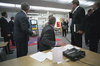 President George W. Bush watches television coverage of the attacks on the World Trade Center Tuesday, Sept. 11, 2001, as he is briefed in a classroom at Emma E. Booker Elementary School in Sarasota, Florida. 