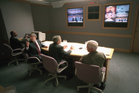 President George W. Bush, is joined by White House Chief of Staff Andy Card, left, and Admiral Richard Mies conduct a video teleconference Tuesday Sept. 11, 2001, at Barksdale Air Force Base in Louisiana. 