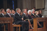 President George W. Bush grasps the hand of his father, former President George H. W. Bush, Friday, Sept. 14, 2001, after speaking at the service for America's National Day of Prayer and Remembrance at the National Cathedral in Washington, D.C. 