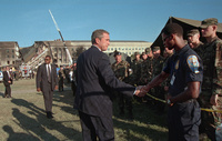 President George W. Bush greets rescue workers, firefighters and military personnel Wednesday, Sept. 12, 2001, while surveying damage caused by the previous day's terrorist attacks on the Pentagon in Arlington, Va.