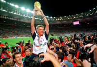 French soccer team coach Aime Jacquet holds aloft the soccer World Cup trophy following the final of the soccer World Cup 98 between Brazil and France. Paris, 1998.