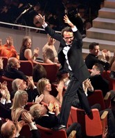 Roberto Benigni celebrates best director win at 1999 Academy Awards. 
