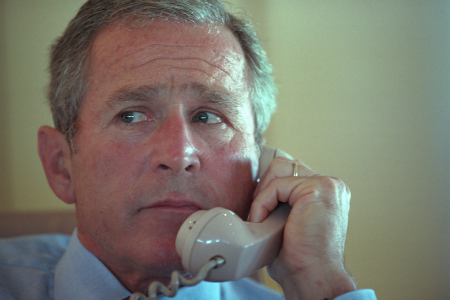 Aboard Air Force One. President George W. Bush talks on the telephone Tuesday, Sept. 11, 2001, 